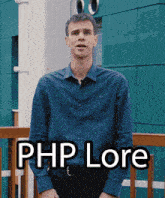 a man in a blue shirt stands in front of a building with the words php lore written on the front