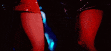 a blurry picture of a woman in a red dress dancing in a club .
