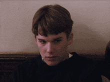 a close up of a young man 's face with his eyes closed