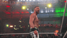 a man in a wrestling ring with a w logo