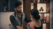 a man and a woman are dancing in a living room .