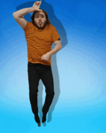 a man with a beard is jumping in the air with his hands on his head