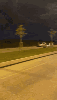 a car is driving down the road at night