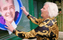 a woman in a leopard print shirt is touching a picture of a man in a blue circle