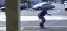 a man is riding a skateboard on a sidewalk in a parking lot .