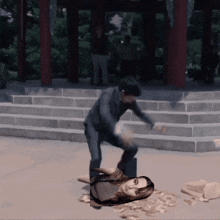 a woman is laying on the ground while a man kicks her