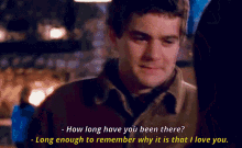 a man in a brown jacket is talking to a woman and says how long have you been there