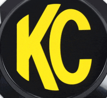 a black circle with a yellow kc logo