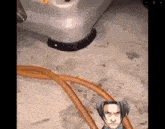a video game character is sitting on the floor next to a stove top oven .
