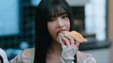 a woman with a tattoo on her face is eating a waffle