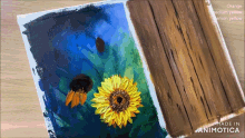 a painting of a sunflower and a painting of a wooden plank