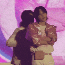 a woman in a pink jacket is standing next to another woman