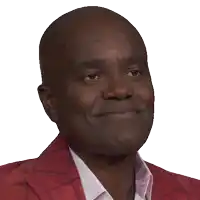 a man wearing a red jacket and a white shirt smiles