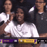 a girl wearing a white shirt that says gallery dept on it