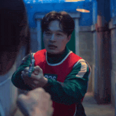 a man in a red and green vest with the number 226 on it