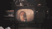 a person holding a remote control in front of a television