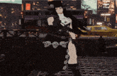 a woman in a black dress and top hat stands in front of a taxi