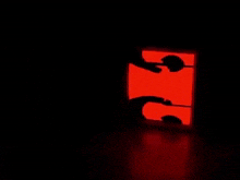 a dark room with a red light shining on it