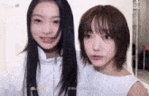 two girls are standing next to each other and one of them has the letters j on her forehead