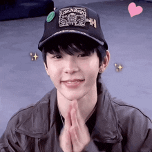a young man wearing a black hat that says guns n roses on it