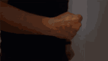 a close up of a man 's fist with a glowing light coming out of it