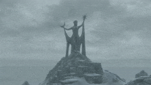 a statue of a woman on top of a snowy hill