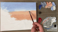 a person is painting on a canvas with the words made in animotica on the bottom