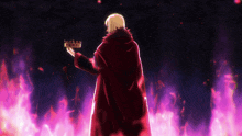 a man in a red coat is holding a crown