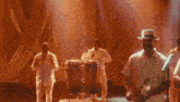 a man sings into a microphone on a stage