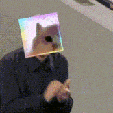 a man is wearing a cube with a cat on it 's head .