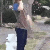 a person standing next to a fire hydrant holding a bottle