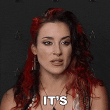 a woman with red hair says priceless in front of a star background