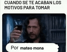 a man is holding a glass of wine in his hand and toasting .