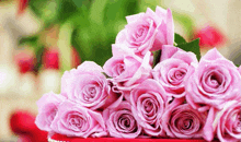 a bunch of pink roses are sitting on a table
