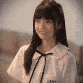 a girl wearing a white shirt with a black bow and a name tag that says jiangsu