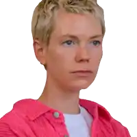a close up of a woman 's face wearing a pink shirt