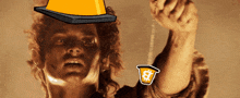 a man with a cone on his head is holding a cup with a dollar sign on it