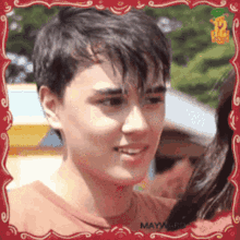 a young man in a red shirt with the word maya on the front