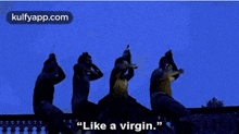 a group of people are dancing in a dark room with the words `` like a virgin '' written on the bottom .