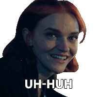 a woman with red hair is smiling and has the words uh-huh written on her face