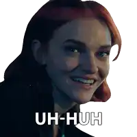 a woman with red hair is smiling and has the words uh-huh written on her face