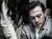 a man with a tear coming out of his eye