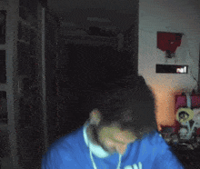 a blurry photo of a person wearing a blue shirt that says ' mexico ' on it