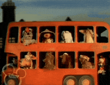 a red double decker bus with disney channel written on it