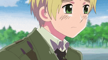 a boy with blonde hair and green eyes is wearing a green jacket and tie