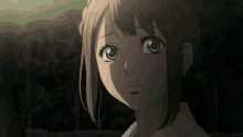 a close up of a girl 's face with a dark background