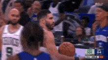 a group of basketball players are playing a game and one of them is holding a basketball .