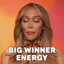 a woman with her eyes closed and the words big winner energy behind her