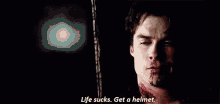 a man with blood on his face is saying `` life sucks . get a helmet '' .