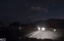 a car is driving down a road at night and the number 960 is on the bottom